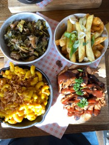 board of food, collard greens, fries, vegan mac and cheese and vegan pulled-chicken BBQ
